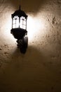 Vintage street lamp against a brick wall at night. Vintage lantern on a white wall. Vintage lantern on the old wall. Vintage Royalty Free Stock Photo