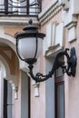 Vintage street lantern on the facade of a stone building wall. Wall lamp outdoor, Kyiv, Ukraine, closeup