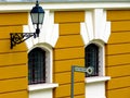 Vintage street lantern on wrought iron bracket. colorful yellow stucco exterior wall Royalty Free Stock Photo