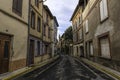 Vintage street leading to main cathedral in the distance of an old town in southern France