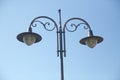 Vintage street light.black street lamp in an open blue sky . Street lantern on background blue sky . Old street light. Royalty Free Stock Photo