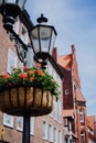 Vintage street light lantern with flowerbed. Medieval facades on the background in Lueneburg Germany Royalty Free Stock Photo