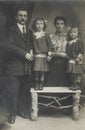 Vintage studio family photo from parents with 2 daughters in 1910, Antwerp