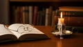 Vintage Study Scene with Open Book, Glasses, and Candlelight Royalty Free Stock Photo