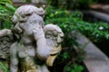 Vintage style angel stone sculpture in the garden, with blurred green plants in background Royalty Free Stock Photo