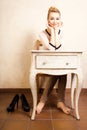 Vintage style. Barefoot girl sitting at retro desk