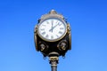 Vintage style black and grey metallic clock towards clear blue sky in Unirii Park (Parcul Unirii), in Bucharest, Romania Royalty Free Stock Photo