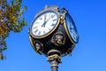 Vintage style black and grey metallic clock towards clear blue sky in Unirii Park Parcul Unirii, in Bucharest, Romania, in a Royalty Free Stock Photo