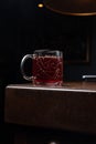 Glass of a tea on a wooden table in a dimly lit environment Royalty Free Stock Photo