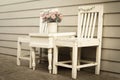 Vintage style color of chair and table with flowers vase. Royalty Free Stock Photo