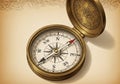A vintage-style compass with a brass casing is shown open. The Royalty Free Stock Photo