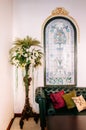 Vintage style house interior with retro leather couch and pillar flower stand. Colonial building interior Royalty Free Stock Photo