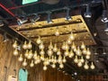 Vintage style light bulbs hanging from a wooden ceiling Royalty Free Stock Photo