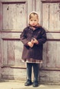 Vintage style. Little cute girl on the background of the old doo Royalty Free Stock Photo