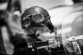 Vintage style motorbike helmet with goggles on the motorcycle handlebar. In Black and White