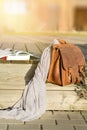 vintage natural leather backpack and books on gray rustic wooden stairs Royalty Free Stock Photo