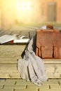 vintage natural leather backpack and books on gray rustic wooden stairs Royalty Free Stock Photo