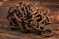 Vintage style, old rusty steel chain, on wooden background Royalty Free Stock Photo