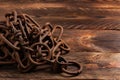 Vintage style, old rusty steel chain, on wooden background Royalty Free Stock Photo