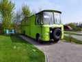 Vintage style old scrap green retro vintage camper on camp site