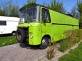 Vintage style old scrap green retro vintage camper on camp site