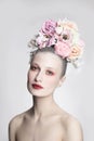 Vintage style portrait of beautiful girl with fancy flower hairdo