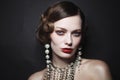 Vintage style portrait of beautiful woman with fancy pearl earrings and necklace Royalty Free Stock Photo