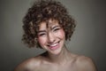 Smiling beautiful young freckled girl with curly hair, selective focus Royalty Free Stock Photo