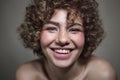 Vintage style portrait of smiling young freckled girl with curly hair, selective focus