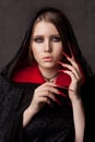 Vintage style portrait of young beautiful vampire woman with gothic Halloween makeup