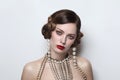 Vintage style portrait of beautiful woman with fancy pearl earrings and necklace Royalty Free Stock Photo