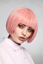 Vintage style portrait of beautiful woman in fancy pink wig