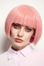 Vintage style portrait of beautiful woman in fancy pink wig