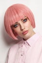 Vintage style portrait of beautiful woman in fancy pink wig