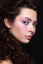 Portrait of young beautiful woman with long curly hair and fancy disco makeup Royalty Free Stock Photo