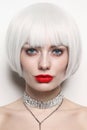 Portrait of young beautiful woman with platinum blonde hair and red lips