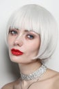 Vintage style portrait of beautiful woman with platinum blonde hair and red lips