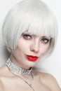 Vintage style portrait of beautiful woman with platinum blonde hair and red lips