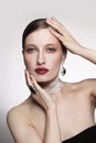 Vintage style portrait of young woman with fancy makeup and lace chocker