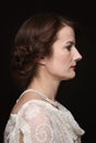 Vintage style profile portrait of mature woman with prom hairdo Royalty Free Stock Photo