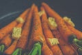 Vintage style rustic carrotts in a pan with butter Royalty Free Stock Photo