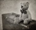 Vintage-style teddy bear and suitcase