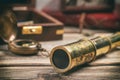 Vintage style telescope on a wooden table. Retro navigation concept. Royalty Free Stock Photo