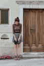 Vintage style toned portrait of a demure young woman