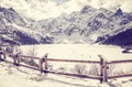 Vintage stylized frozen lake Morskie Oko in Polish Tatra Mountains. Royalty Free Stock Photo