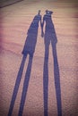 Vintage stylized picture of couple's shadow on beach