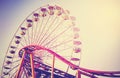 Vintage stylized picture of ferris wheel at sunest.