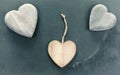 Vintage stylized three wooden hearts on stone background. Royalty Free Stock Photo