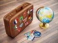 Vintage suitcase with flags of world countries, globe, compass and plane tickets. 3D illustration Royalty Free Stock Photo