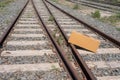 Vintage suitcase on the old rusty railroad tracks overgrown with grass and flowers Royalty Free Stock Photo